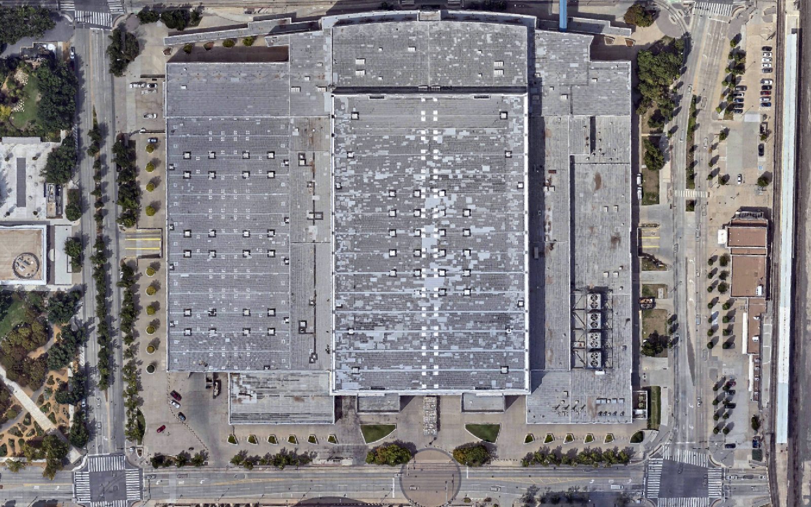 A downtown Oklahoma City block on 2022-09-09 straight down from above: the convention center roof intact, the streets and parking around it as they were