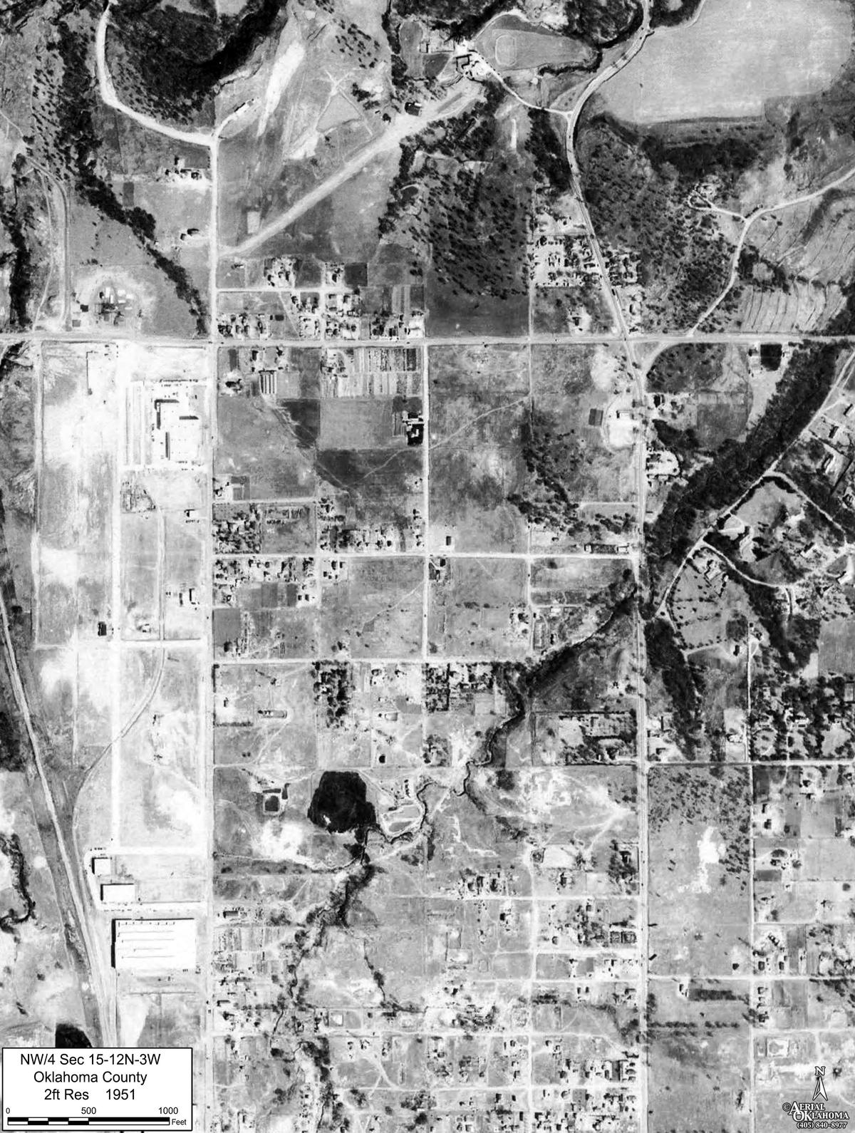 1951: the first long industrial buildings along the west edge, the north half still fields