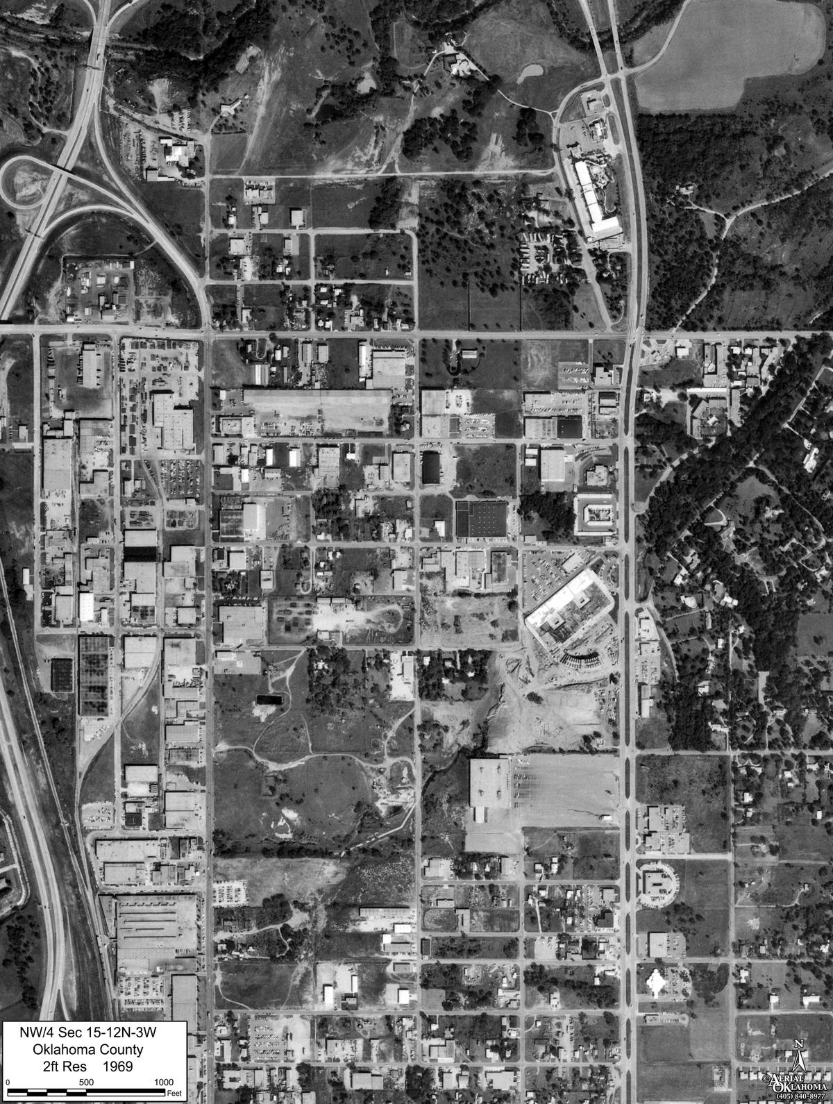1969: the freeway interchange built at the northwest corner and warehouse blocks filling the west half