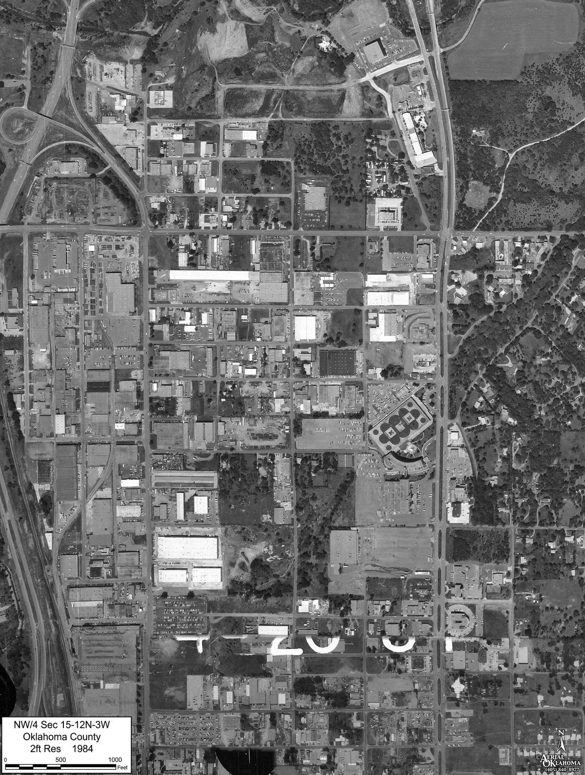 1984: warehouses and yards on nearly every block west of the creek, the east side still wooded